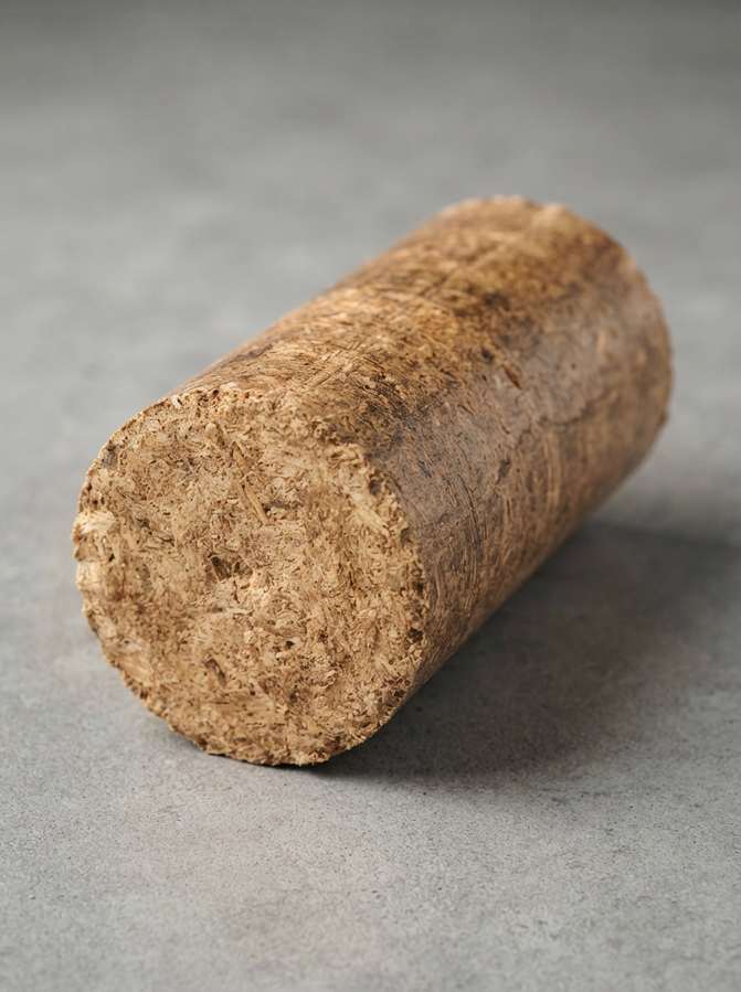 Single solid briquette close-up on grey background